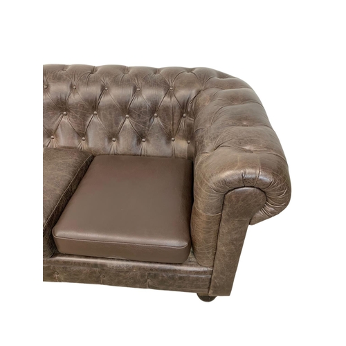 959 - A large deep button brown leather Chesterfield sofa. 223 x 91 x 83cm