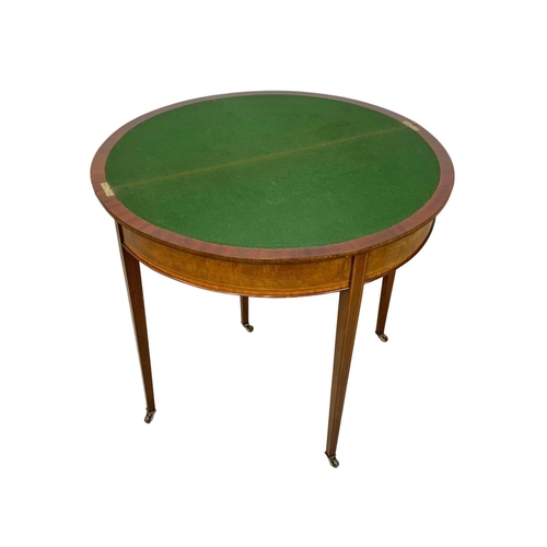 963a - An Edwardian Sheraton revival inlaid mahogany turnover games table. 84 x 41.5 x 76cm.