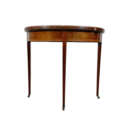 963a - An Edwardian Sheraton revival inlaid mahogany turnover games table. 84 x 41.5 x 76cm.