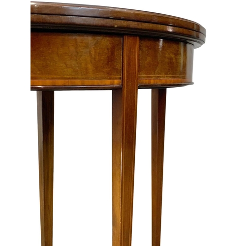 963a - An Edwardian Sheraton revival inlaid mahogany turnover games table. 84 x 41.5 x 76cm.