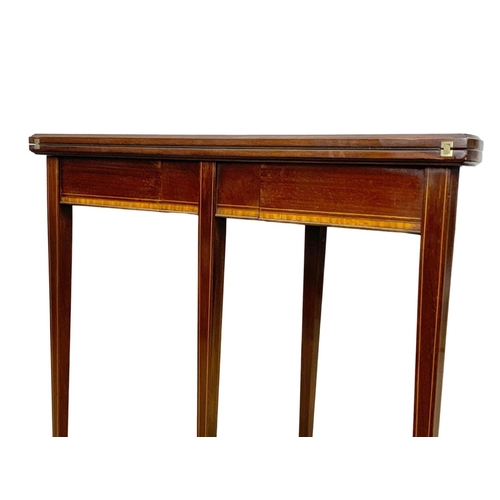 963a - An Edwardian Sheraton revival inlaid mahogany turnover games table. 84 x 41.5 x 76cm.