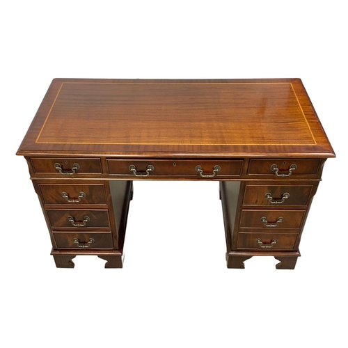 966 - A Georgian style inlaid mahogany pedestal desk. 123.5 x 61 x 77.5cm.