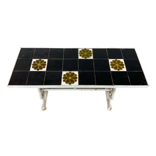 977 - A Victorian cast iron garden table with a 1950s tile top, 125cm x 48.5cm x 76cm