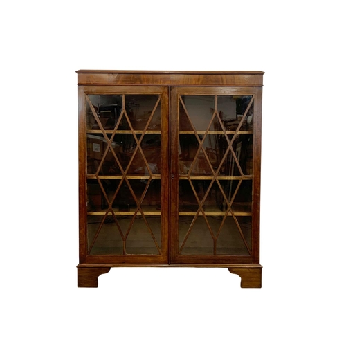 982 - A large Victorian mahogany double glazed door bookcase. 112 x 40.5 x 122.5cm