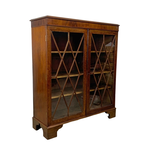 982 - A large Victorian mahogany double glazed door bookcase. 112 x 40.5 x 122.5cm