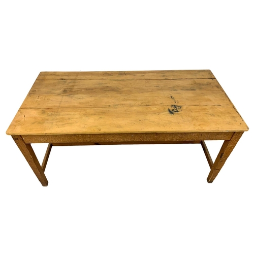 986 - A large late 19th century pine farmhouse table with stretcher support and original refinished top. C... 