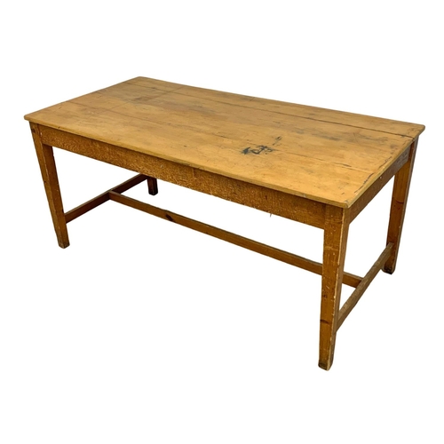 986 - A large late 19th century pine farmhouse table with stretcher support and original refinished top. C... 