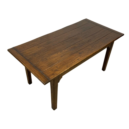 988 - An 18th century style oak farmhouse table with square tapered legs. 168.5 x 83.5 x 77cm