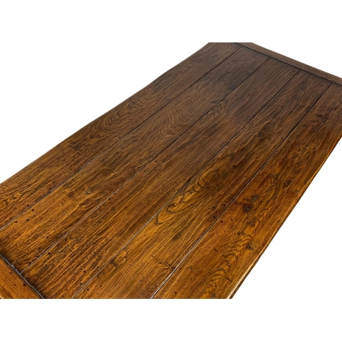 988 - An 18th century style oak farmhouse table with square tapered legs. 168.5 x 83.5 x 77cm