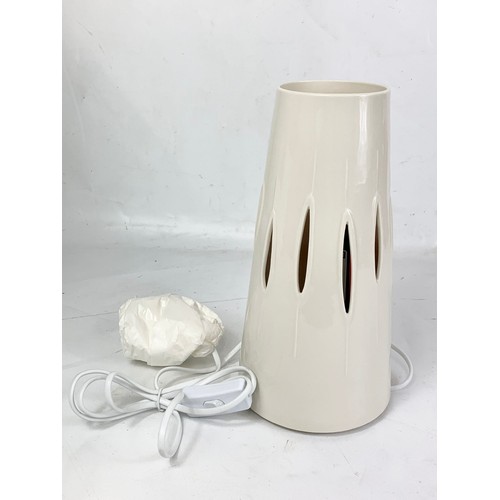 497 - A Belleek Living table lamp in box. Lamp measures 28cm