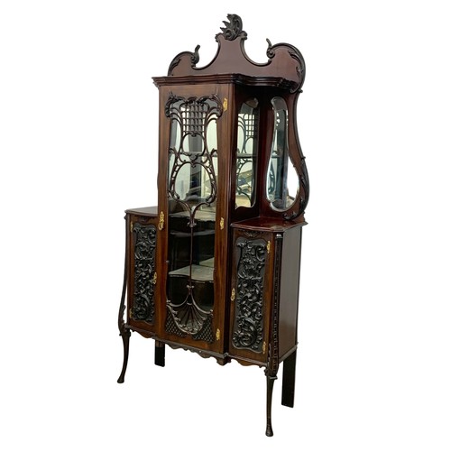 1031 - A late Victorian ornate mahogany display cabinet. Circa 1890-1900. 104.5 x 36 x 221cm.