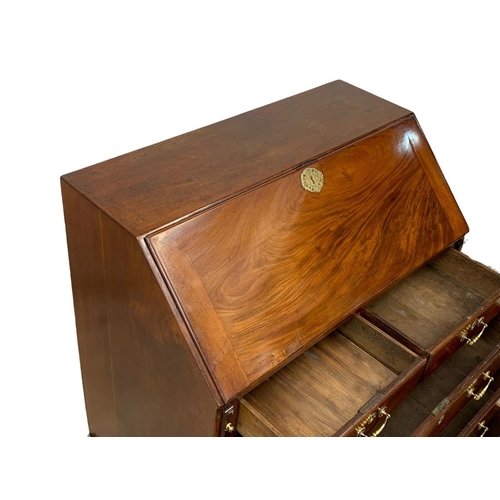 815 - A large Georgian mahogany writing bureau with brass drop handles. Circa 1760-80. 102.5 x 56.5 x 109.... 