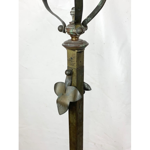 219 - An early 20th century Art Nouveau brass standard lamp base. 152.5cm.