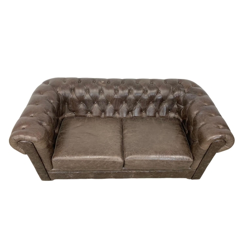 976 - A deep button brown leather Chesterfield sofa. 185 x 96 x 79cm