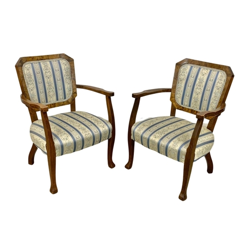 857a - A pair of 1930's armchairs in a beech frame with simulated walnut back rest.