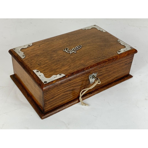 1 - An Edwardian oak cigar box with sterling silver mounts, London 1902. 24.5 x 15.5 x 8cm.