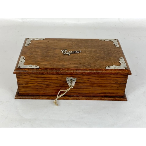 1 - An Edwardian oak cigar box with sterling silver mounts, London 1902. 24.5 x 15.5 x 8cm.