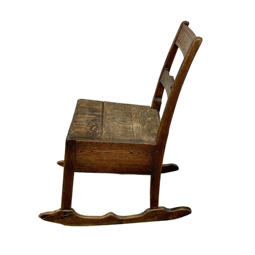 1002 - A small Orkney oak and elm rocking chair. Early 19th century. Circa 1820