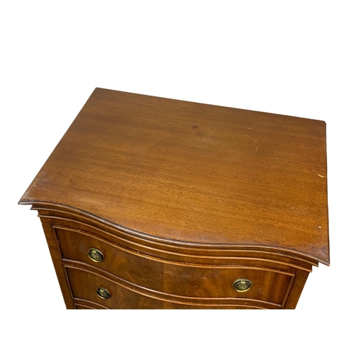 1006 - A tall Georgian style mahogany serpentine front chest of drawers. 55 x 41 x 131cm.