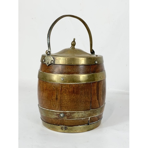 101 - An Edwardian oak brass bound biscuit barrel and a pair of small Mortar & Pestals.