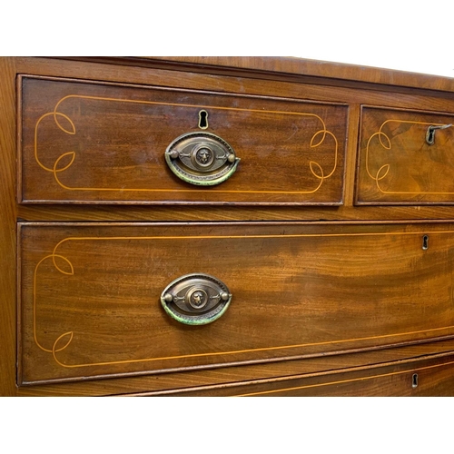 1011 - A large Georgian inlaid mahogany bow front chest of drawers. Circa 1800-1820. 113.5 x 57 x 105cm.