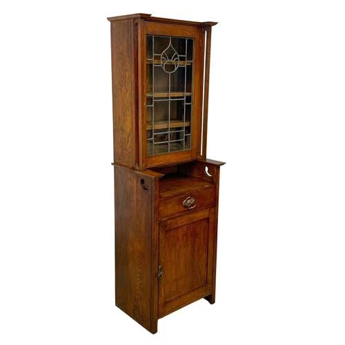 1013 - An Arts & Crafts oak single display cabinet. Circa 1900. 62 x 47.5 x 198cm