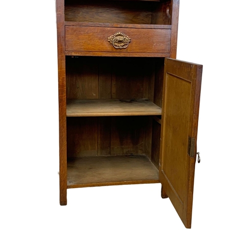 1013 - An Arts & Crafts oak single display cabinet. Circa 1900. 62 x 47.5 x 198cm