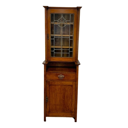 1013 - An Arts & Crafts oak single display cabinet. Circa 1900. 62 x 47.5 x 198cm