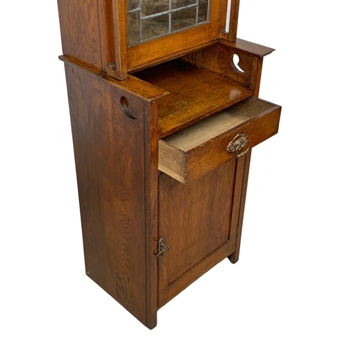 1013 - An Arts & Crafts oak single display cabinet. Circa 1900. 62 x 47.5 x 198cm