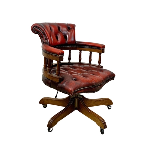 1026 - A deep button ox-blood leather swivel captains desk chair