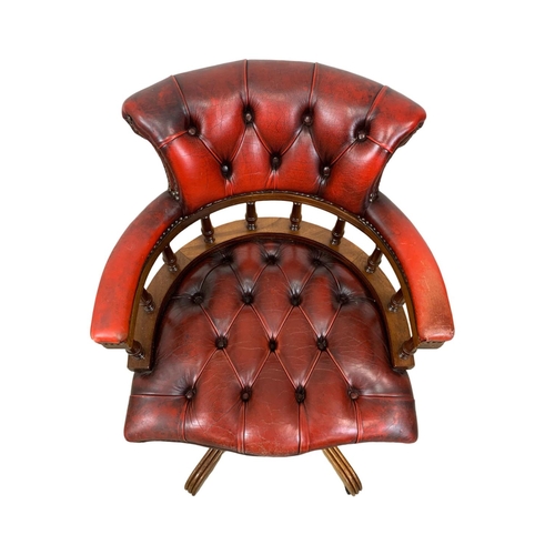 1026 - A deep button ox-blood leather swivel captains desk chair