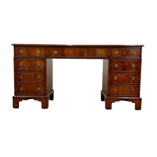 1027 - A Georgian style mahogany pedestal desk. 154 x 50 x 76cm.