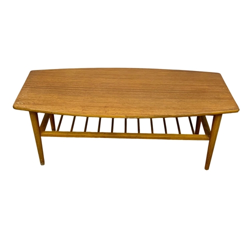 1029 - A Mid Century teak and beech 2 tier coffee table. 119.5 x 54.5 x 45cm.