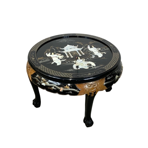 1030 - A Chinese lacquered coffee table with 4 nesting tables. 80 x 53cm.