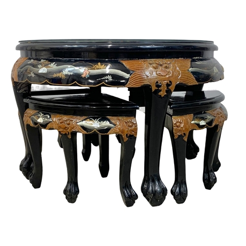 1030 - A Chinese lacquered coffee table with 4 nesting tables. 80 x 53cm.