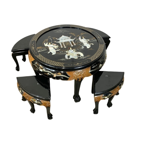 1030 - A Chinese lacquered coffee table with 4 nesting tables. 80 x 53cm.