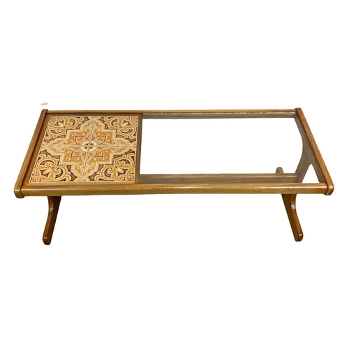 1031 - A G-Plan teak and glass top Mid Century coffee table with tiles. 122 x 50 x 43cm.