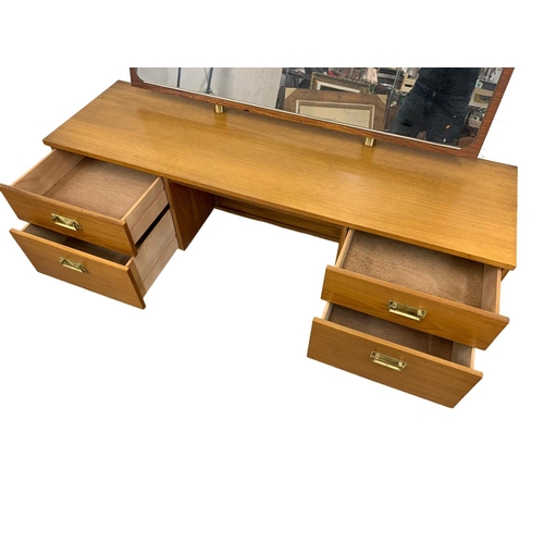 1032 - A teak Mid Century dressing table. 151 x 45 x 113cm.