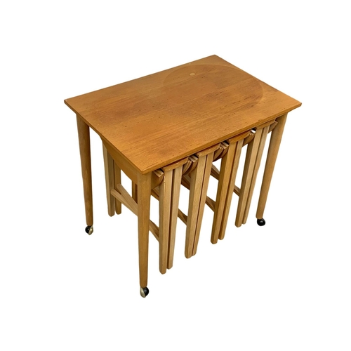 1041 - A Danish teak nest of tables designed by Poul Hundevad. 62 x 42 x 56.5cm