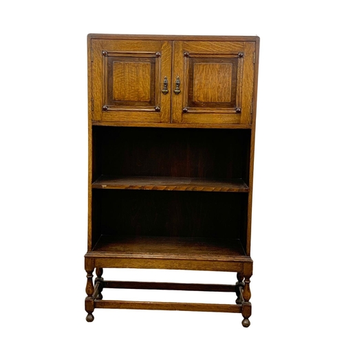 1045 - A 1930’s oak bookcase with 2 door cupboard. 61 x 22 x 107cm