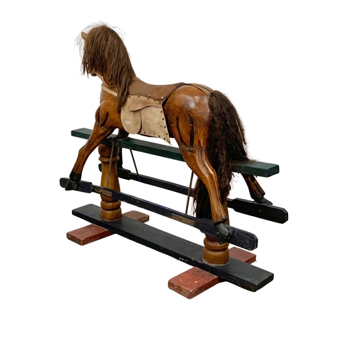 1055 - A large wooden rocking horse. 134 x 117cm.