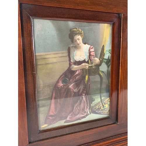 117 - An Edwardian mahogany wall mirror with prints of ladies. 99 x 10 x 47cm