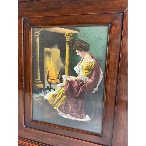 117 - An Edwardian mahogany wall mirror with prints of ladies. 99 x 10 x 47cm