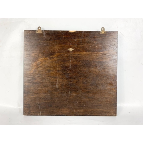 131 - A vintage oak wall mirror. 37 x 33.5cm