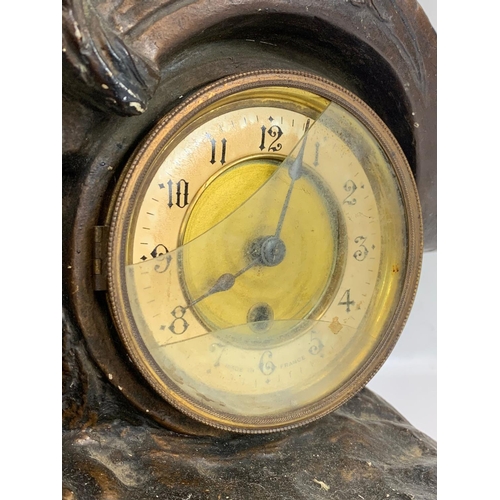 137 - A large 19th century French mantle clock on slate base with a pair of late 19th century spelter figu... 