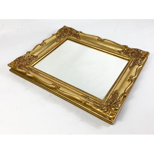 146 - A pair of ornate gilt framed mirrors. 31 x 36cm