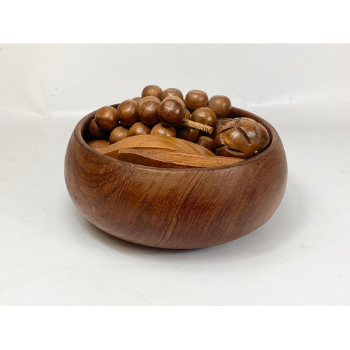 18 - A Mid Century teak fruit bowl with artificial wooden fruit. 1960’s. 26 x 11cm.