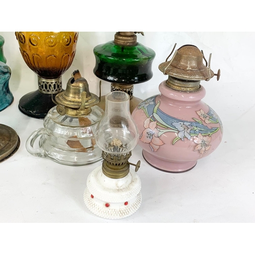 242 - A quantity of oil lamps. Tallest 41cm