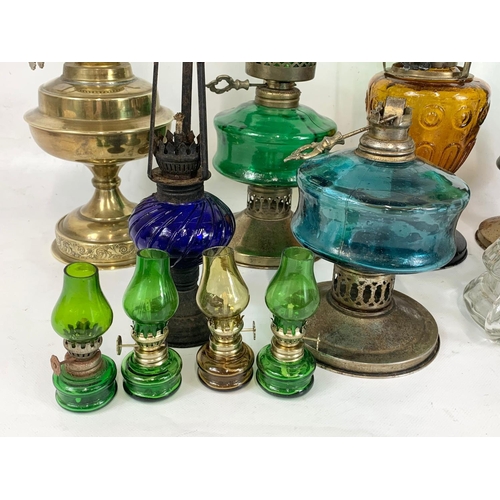 242 - A quantity of oil lamps. Tallest 41cm