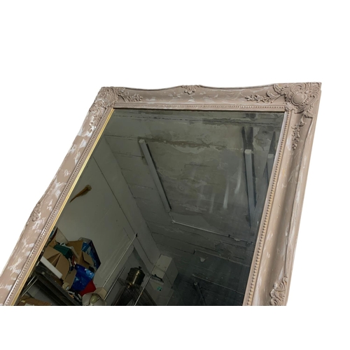 253 - A large ornate framed mirror. 75 x 105cn